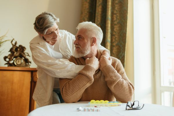 Elderly couple sharing a tender moment at home, expressing love and companionship.