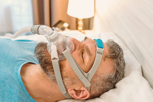 man sleeping with a cpap mask on