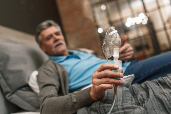 Older man holding a cpap mask