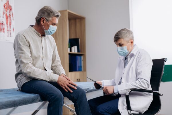 doctor talking to patient in office