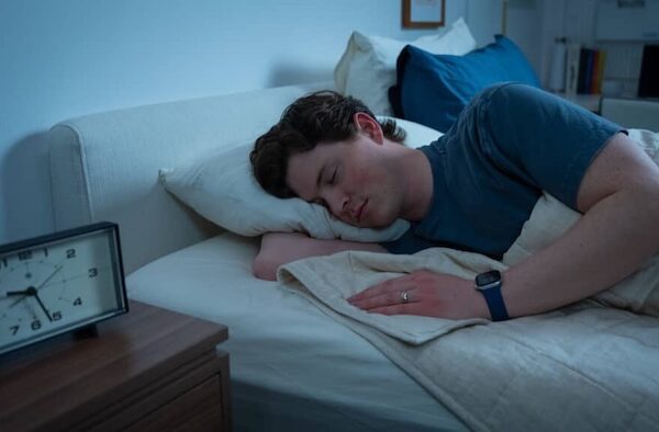 Person sleeping while wearing an Apple Watch