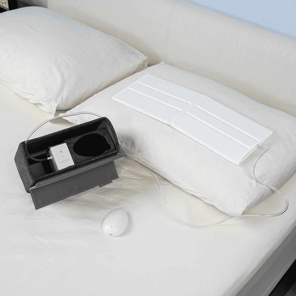 Smart Nora being used on top of a mattress and pillow