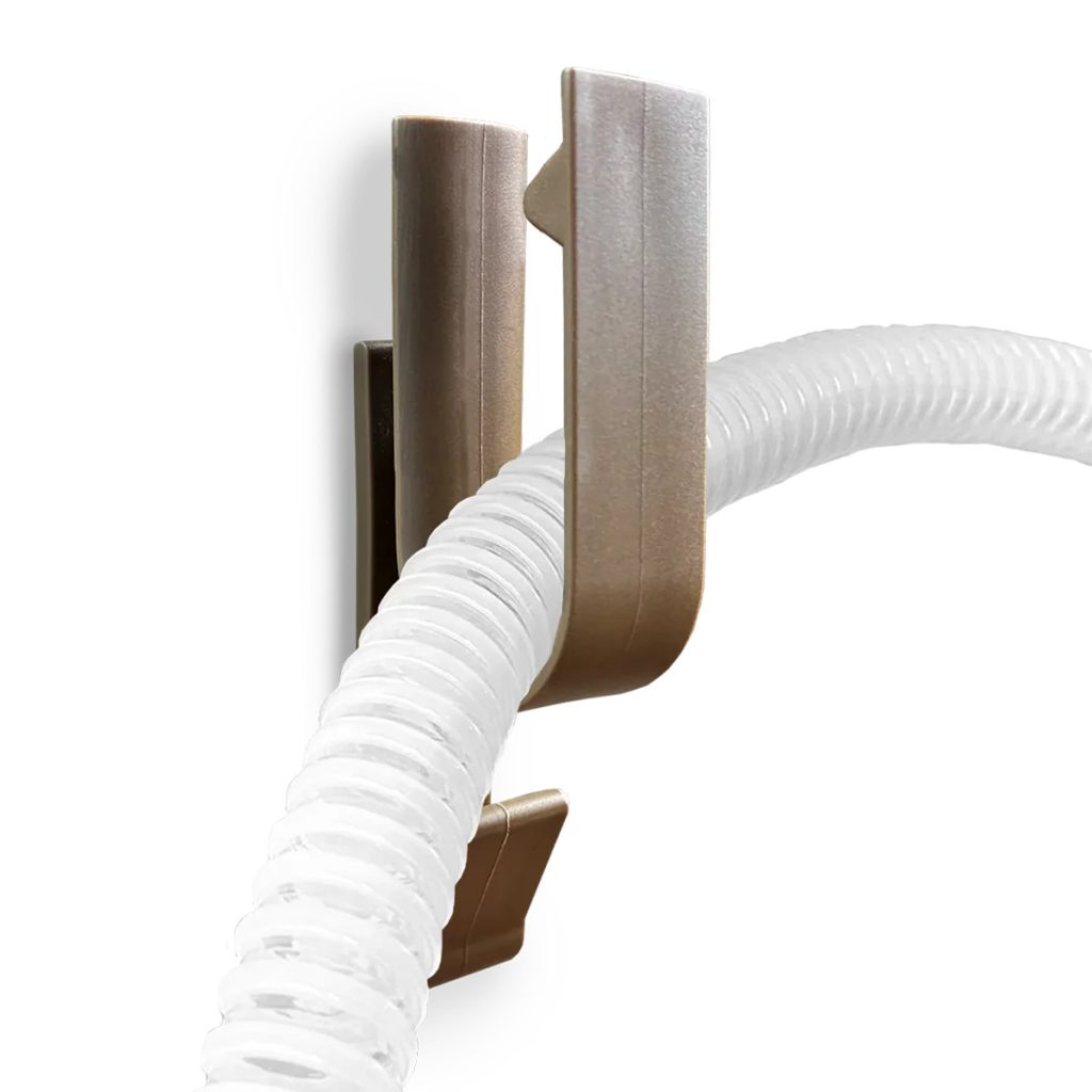 Brown version of OtenMedical CPAP Hose Holder holding CPAP tubing against a white backdrop